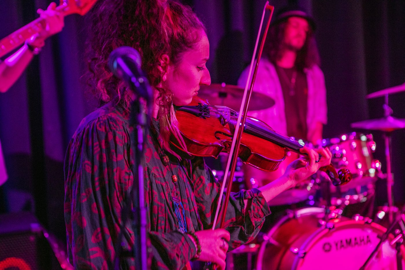 violin player in magenta light